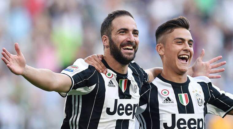 Juventus's Gonzalo Higuain, left, celebrates with his teammate Paulo Dybala after scoring during a Serie A soccer match between Juventus and Sassuolo at the Juventus Stadium in Turin, Italy, Saturday, Sept. 10, 2016. (Alessandro Di Marco/ANSA via AP)
